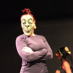 woman with arms akimbo wearing silly mask woman with arms akimbo wearing silly mask